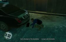 Niko Bellic placing a bomb under the car of Anthony Spoleto.