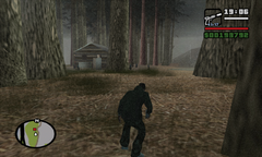 Carl Johnson creeps up on the cabin and watches the guards' patrol.