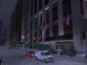 The skyscraper block on the western side of the district, GTA III. The second building from the right (with a facade featuring blue glass) is labeled housing "Orbit".