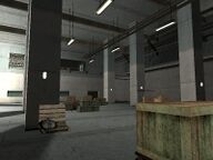 A large room containing wooden crates on the first floor.