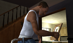 Carl Johnson picks up a picture of his mother and looks at it sadly.