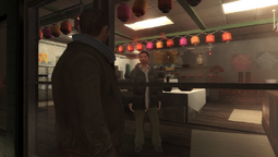 Niko Bellic talking to the store owner.