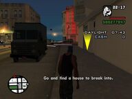 The player creeping towards a house.