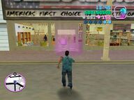 Tommy Vercetti about to enter Ammu-Nation to drop off the briefcase.