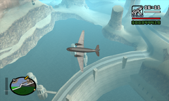 Carl Johnson's plane flies over the Sherman Dam as he prepares to make his jump.