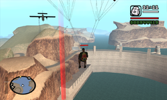 CJ parachutes onto the dam.