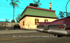 Two members of the Kilo Tray Ballas passing by the Cluckin' Bell and heading for Grove Street.
