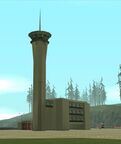The airport's control tower in GTA San Andreas. Note a pair of red doors on the left side of the building, presumably for the airport's fire station.