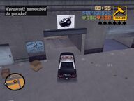 Claude about to have a car bomb placed in a Police Car at Eightballs Autoyard.