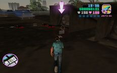 Tommy Vercetti about to collect the briefcase after killing the Sharks gangsters and men in black attire.
