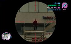 Tommy Vercetti about to shoot a man in black attire on the stairway leading to the Bakery & Cafeteria roof.