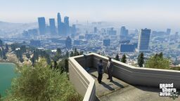 Michael and Franklin looking at Los Santos cityscape.