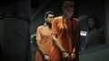 Lucia is standing in line and is being stared at aggressively by an inmate