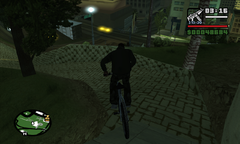 Carl bikes away from Madd Dogg's mansion and back into Los Santos.