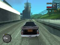 Toni Cipriani driving Donald Love and Ned Burner's corpse to Love's hangar at Francis International AIrport.