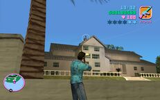 Tommy Vercetti shooting a Sharks gangster on the mansions roof.