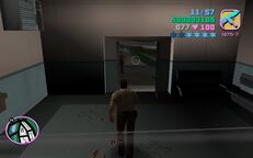 Tommy Vercetti about to leave the police station as bullets fly past him.
