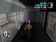 Tommy Vercetti walking towards Cam Jones' holding cell.