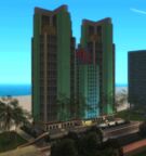 The same beachfront hotel in GTA Vice City Stories. The building receiving modified building textures and prominently multicolored neon lights that illuminate at night.