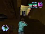 Tommy Vercetti shooting a Sharks gangster guarding the access to the roof.