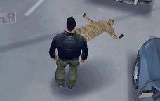 Claude standing over the deceased body of Ray Machowski's former partner.