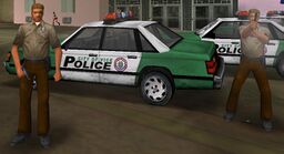 Hostile police officers in GTA Vice City, with their brown uniform and police cars.