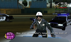 A police officer jumps onto Sweet's car during the chase.