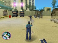 Tommy Vercetti shooting one of the security guards.