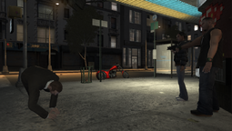 Niko Bellic diving out of the Jayvon Simson's line of fire, as Cherise Glover looks on.