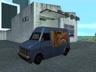 A Cok O Pops Rumpo in front of a Pay 'n' Spray.