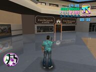 Tommy Vercetti shooting at the windows of the Tarbrush Café store.