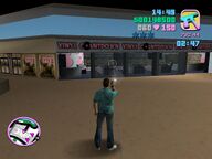 Tommy Vercetti shooting at the windows of the Vinyl Countdown store.