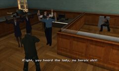 Carl Johnson keeps his gun on the people in the bank while Catalina attempts to open the safe