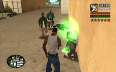 CJ attacks two Ballas with his spray can.