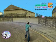 Tommy Vercetti shooting a guard at the Boatyard.
