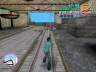 Tommy Vercetti shooting a guard inside the hangar.