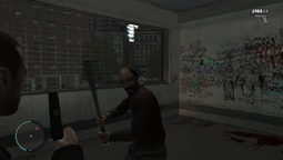 Niko being attacked by a homeless man inside Dwayne's apartment.