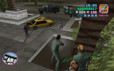 Tommy Vercetti shooting a SWAT officer as Phil Cassidy and Cam Jones take cover.