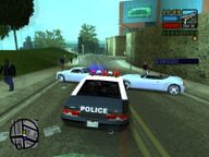 Toni Cipriani, in the police car, about to break a Sicilian Mafia blockade.