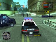 Toni Cipriani, in the police car, about to break a Sicilian Mafia blockade.