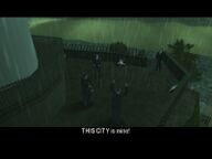 Toni Cipriani and Salvatore Leone confronting Massimo Torini, who holds Mayor Miles O'Donovan at gun point.