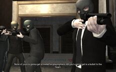 Niko, Packie and Derrick threatening the hostages.