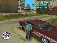 Tommy Vercetti about to steal a Haitian Voodoo from outside Auntie Poulet's house.