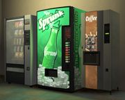 A Sprunk vending machine between two non-interactive vending machines: One for snacks (left) and the other for coffee (right).