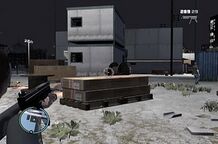 Niko Bellic shooting at the warehouse employees.