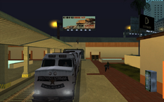The Los Santos Vagos attempt to escape by riding on top of the Brown Streak train, with Carl Johnson and Big Smoke running for a vehicle to chase them with.