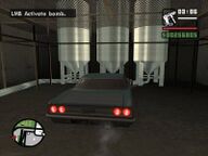 Carl Johnson parking the rigged car inside the factory.